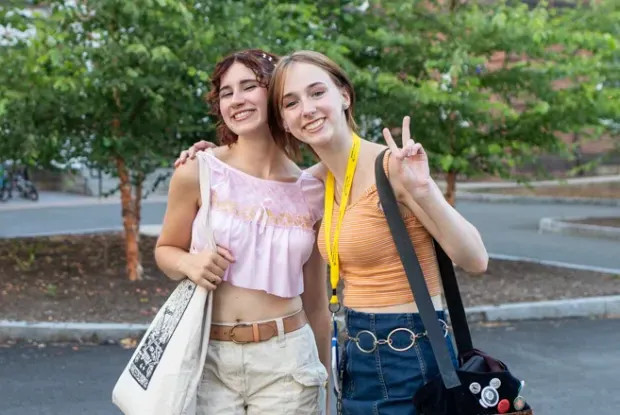 Two precollege students smiling.